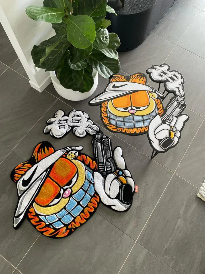 Handmade tufted cartoon rug with orange cat wearing visor, holding smoking toy gun, on grey tiles