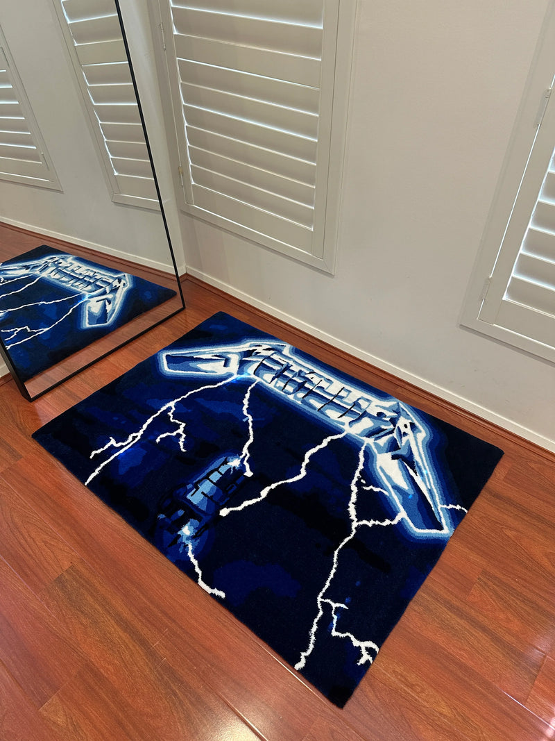 Handmade tufted rug with blue lightning and electric guitar design on wooden floor