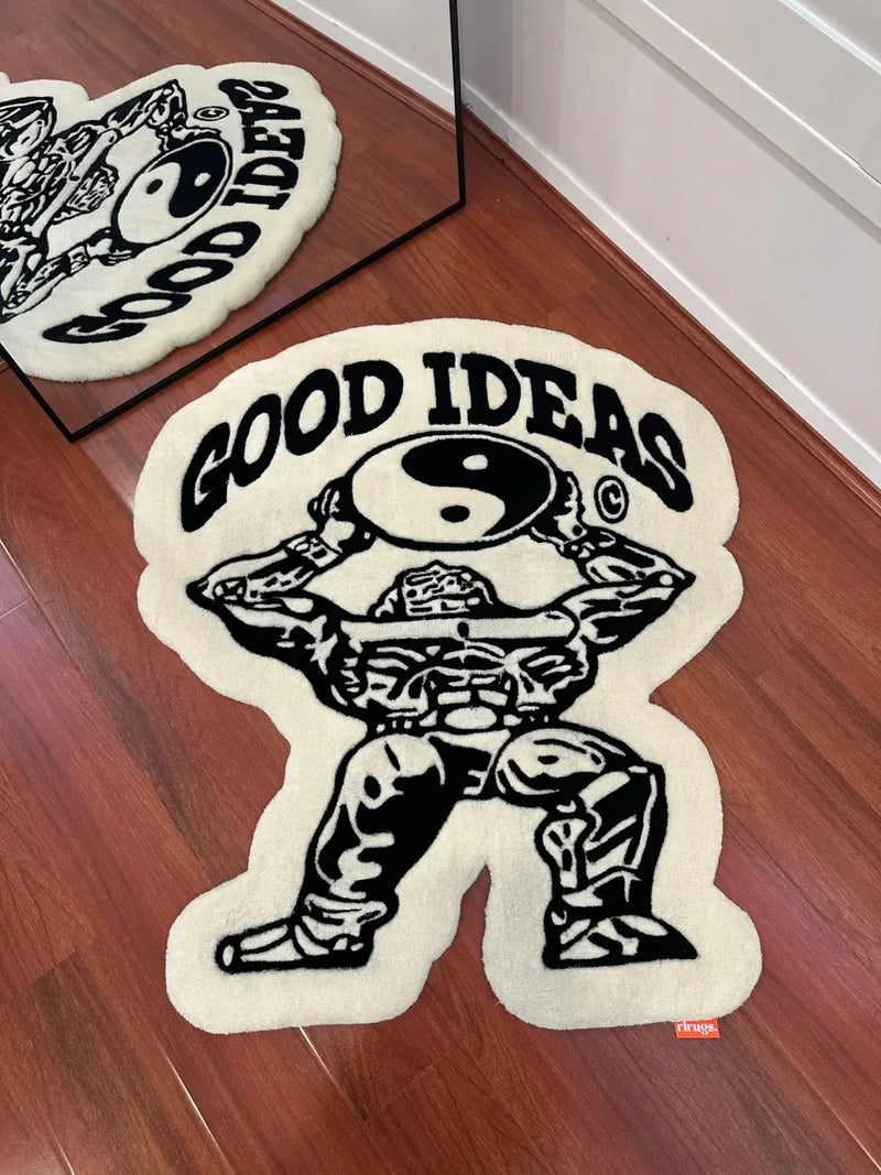 Handmade tufted rug with a cartoon figure holding a yin yang symbol and 'GOOD IDEAS' text, on wood floor