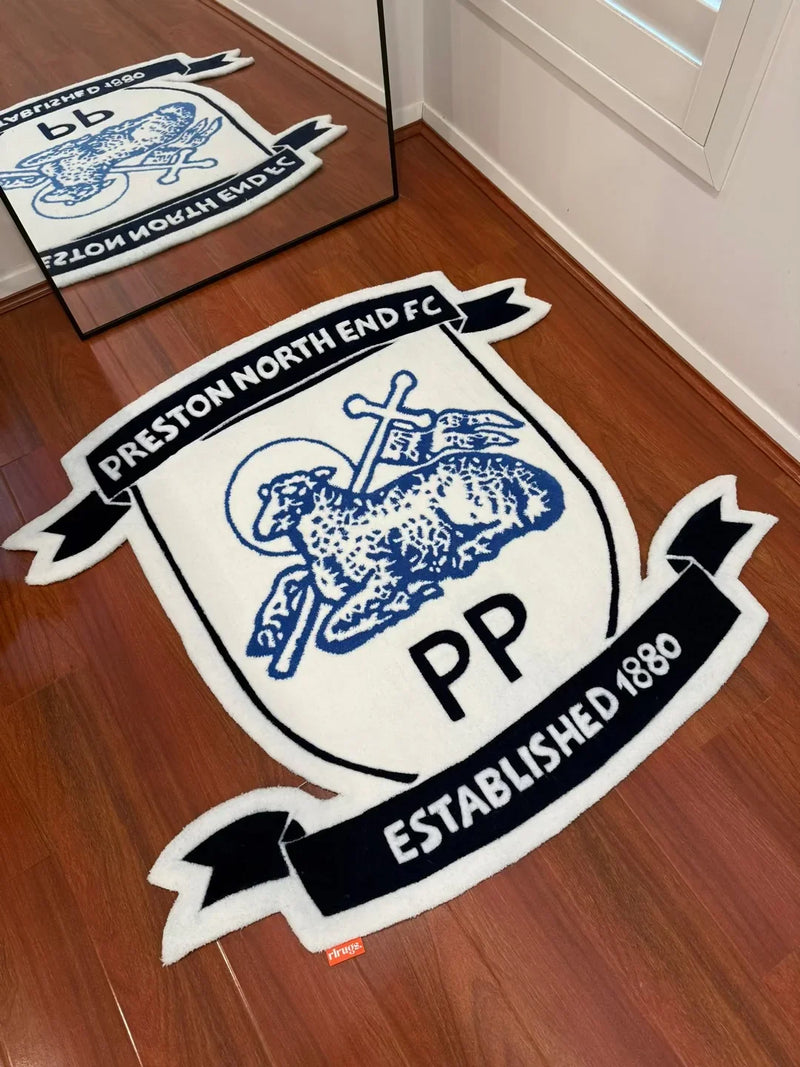 Handmade Preston North End FC tufted rug with club logo on wooden floor, reflected in mirror