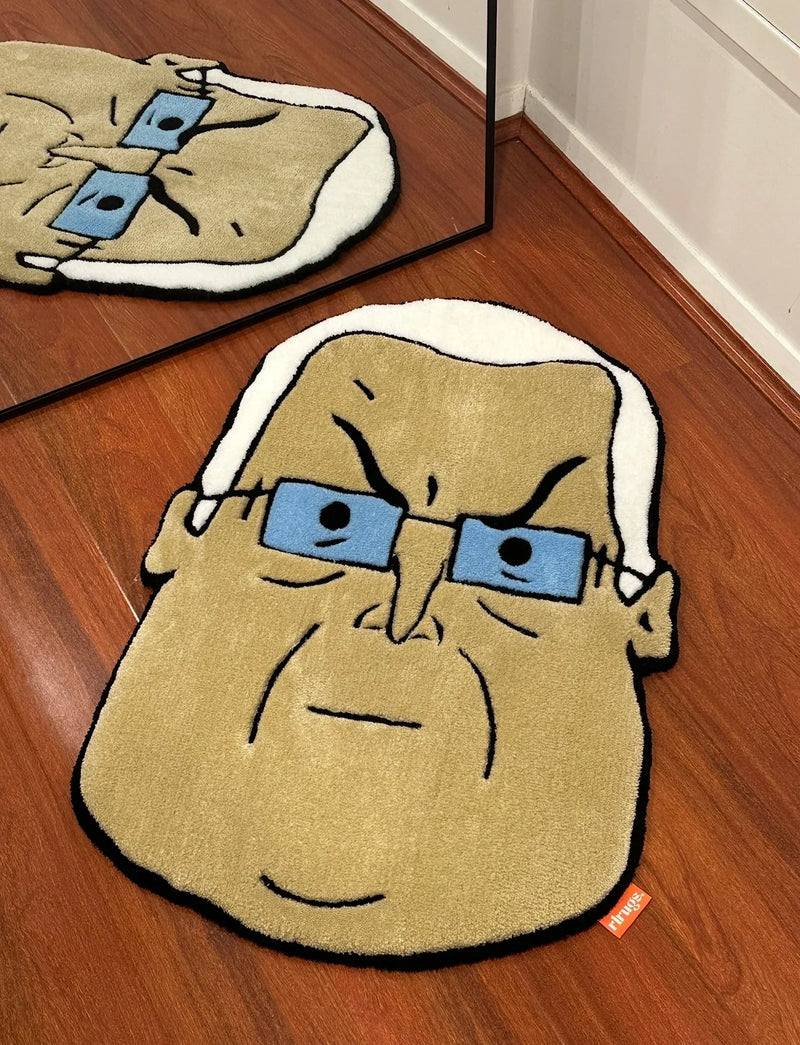 Handmade tufted rug of a cartoon face with glasses and white hair on wooden floor