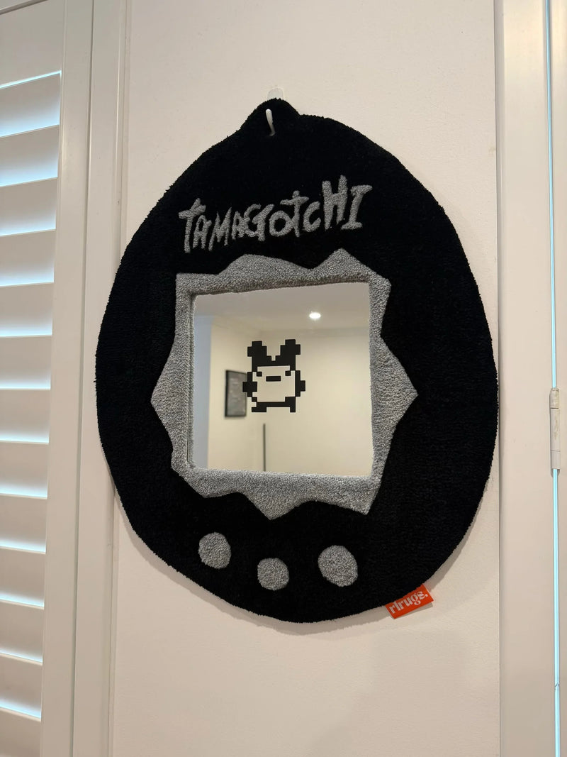 Handmade tufted Tamagotchi-inspired wall mirror with pixel art design, black and grey colors